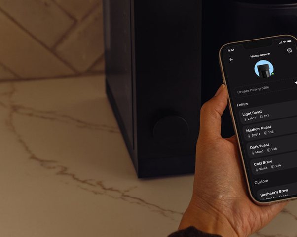 Fellow app on a phone showing brew profiles, next to the brewer